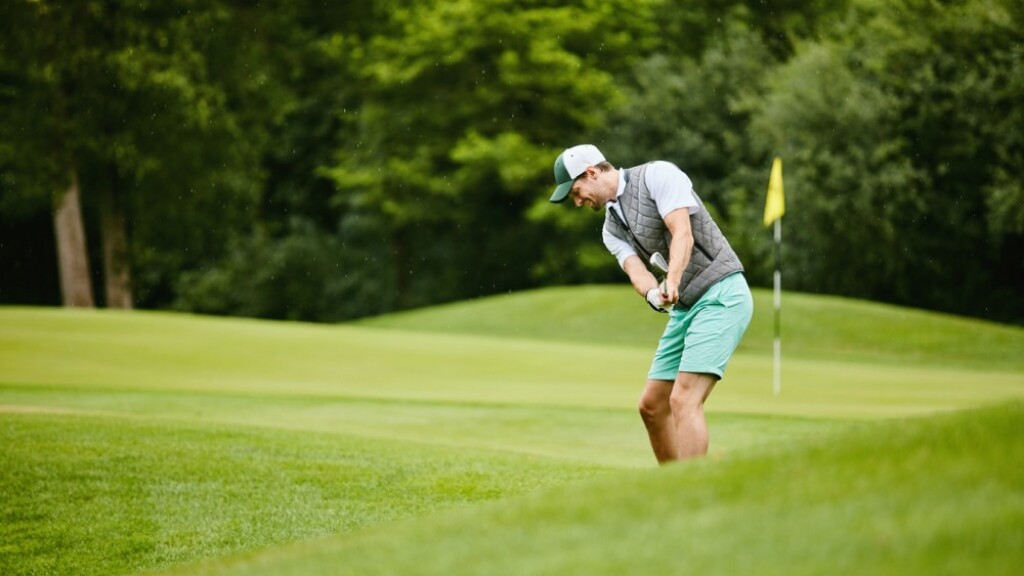 Golfer taking a swing on golf course